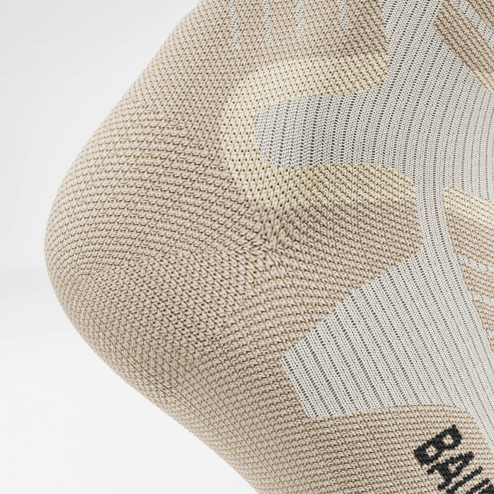 Detail van de hielbeschermingszone van de beige sportsokken voor skiën met merinowol