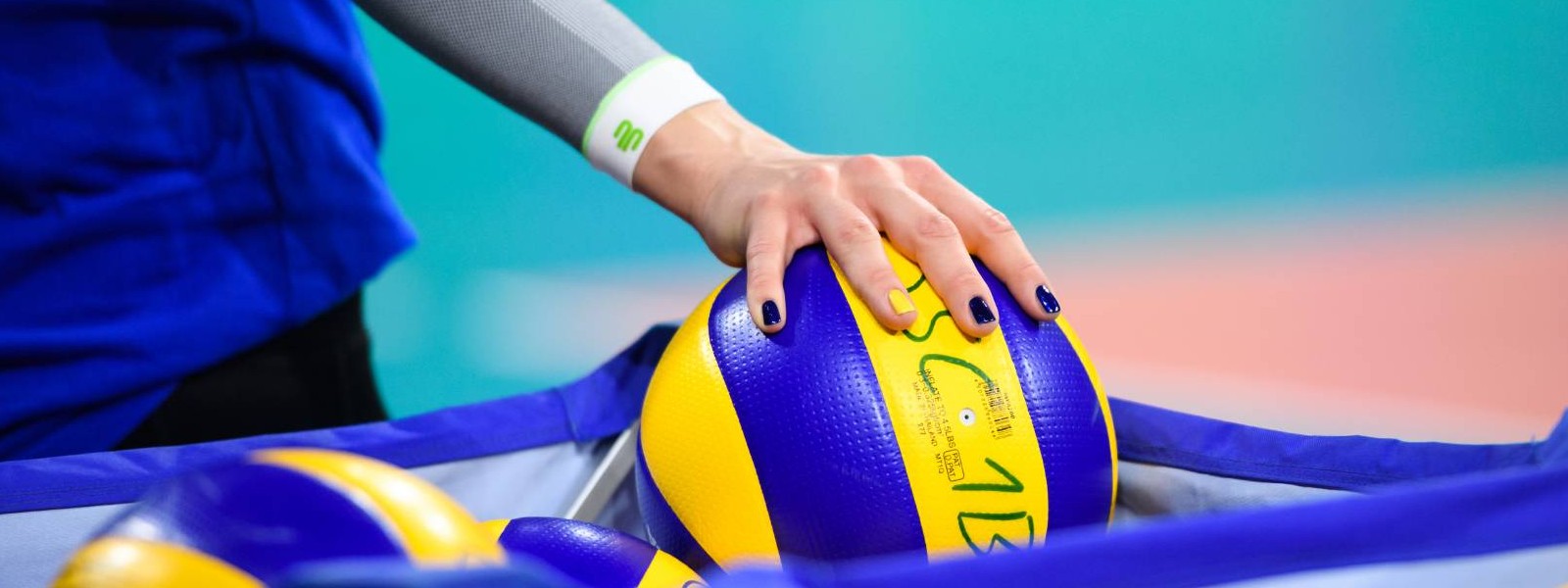 Volleybalspeler met witte arm mouwen pak een volleybal
